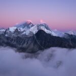 A beautiful scenery of the summit of Mount Everest covered with snow under the white clouds